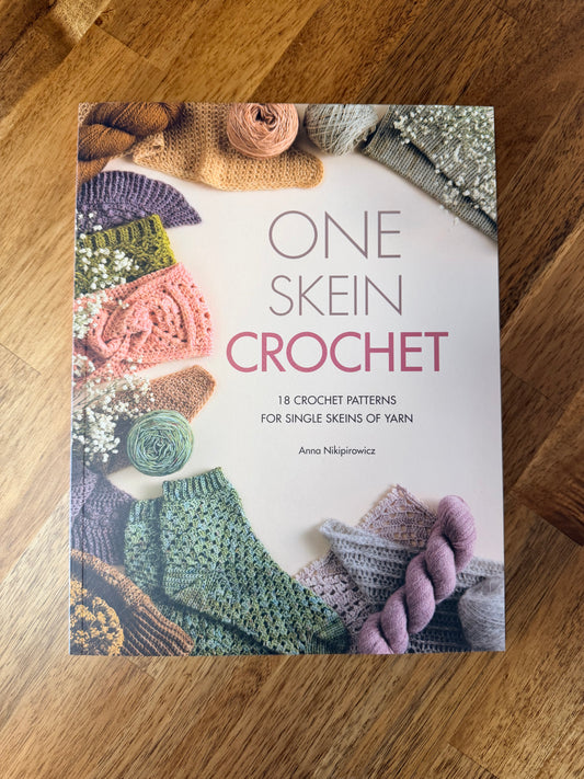 One Skein Crochet book by Anna Nikipirowicz showing crochet accessory patterns made from a single skein of yarn, including shawls, socks, scarves and mittens.